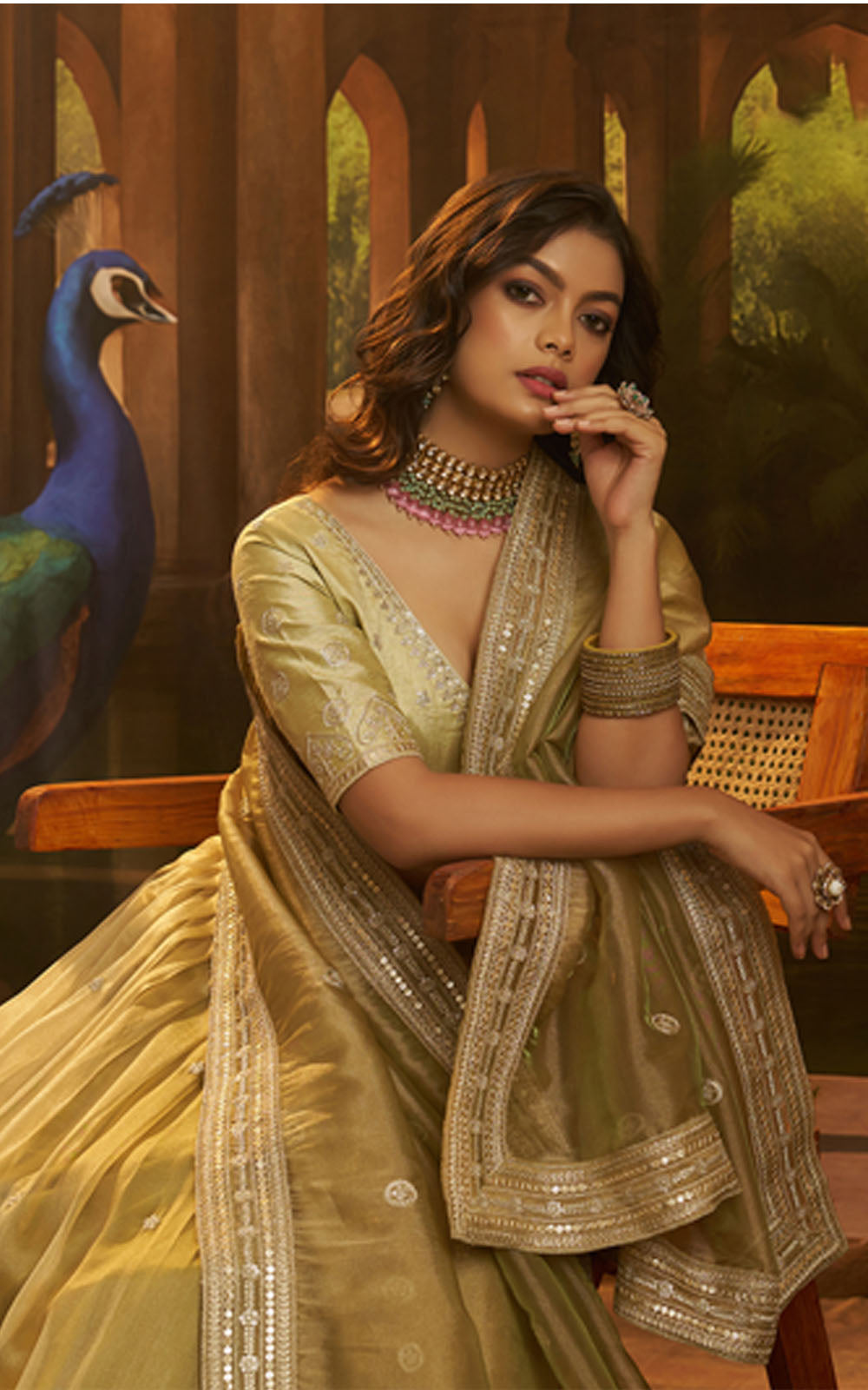 Woman in a traditional outfit with a peacock in the background