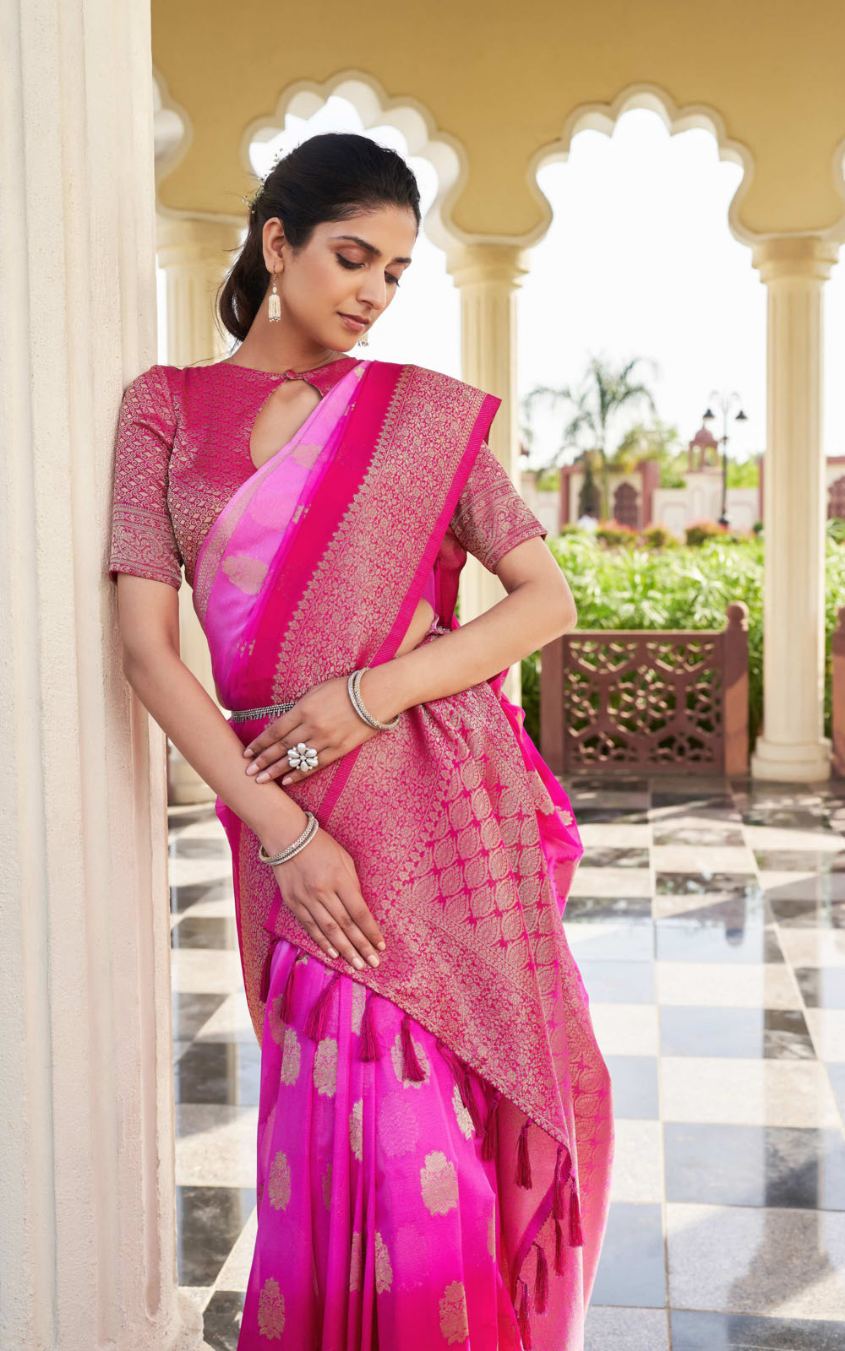 Woman wearing a pink saree with a traditional setting