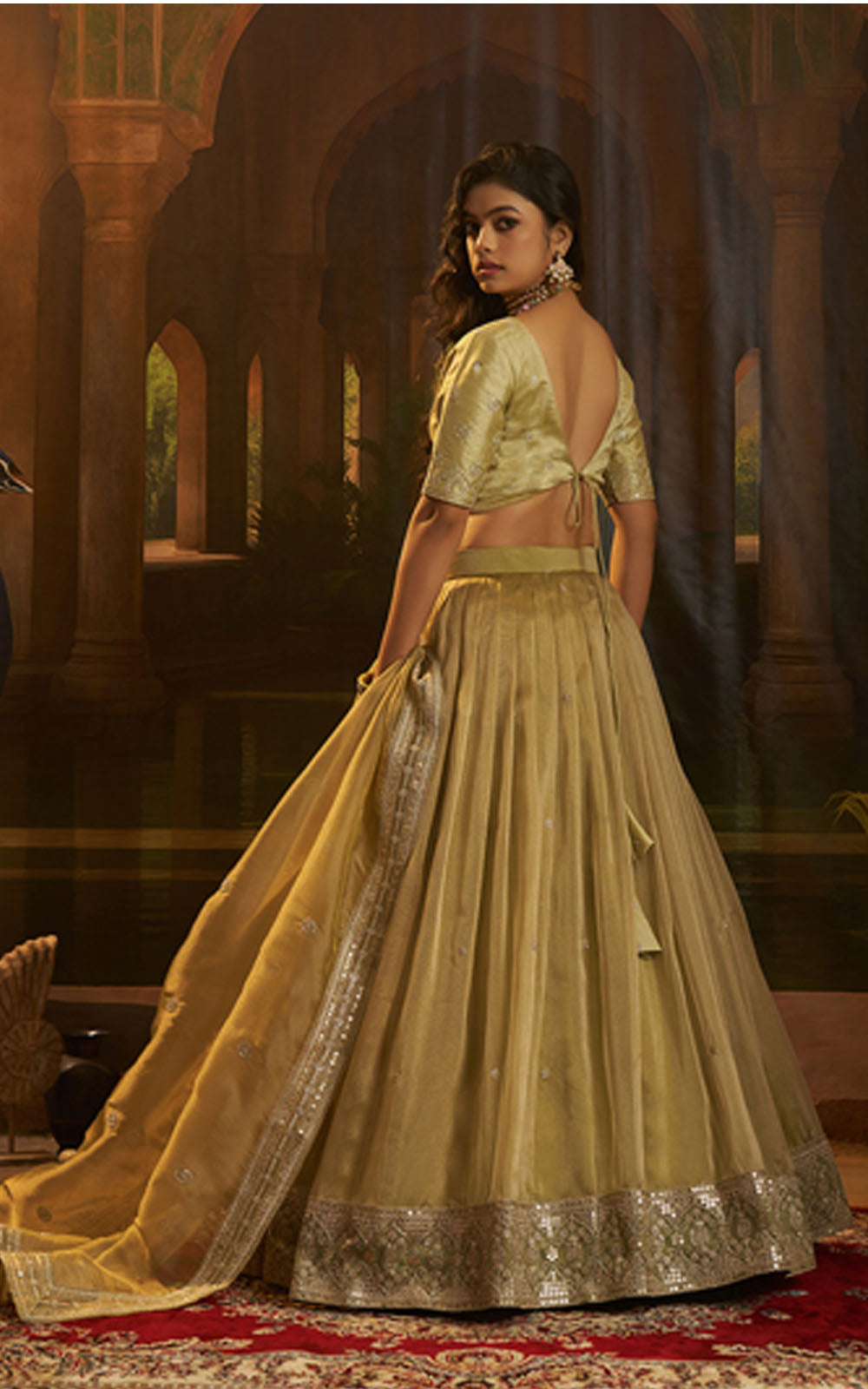 Woman in a green traditional outfit with a detailed background