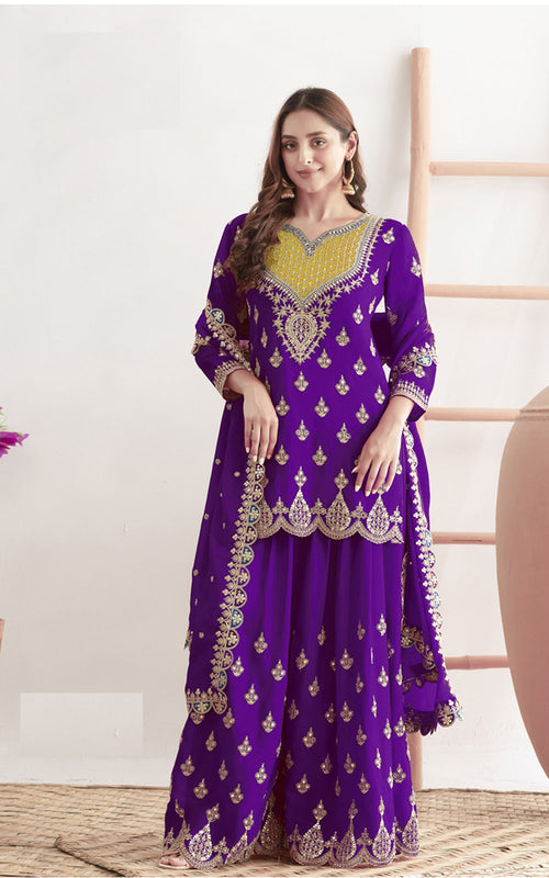 Woman wearing a purple traditional outfit with gold embroidery in a minimalistic setting