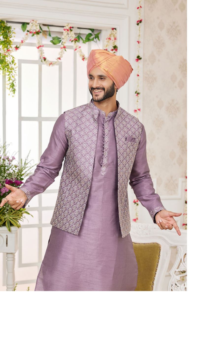 Man wearing a traditional purple Jacket with a matching turban indoors.