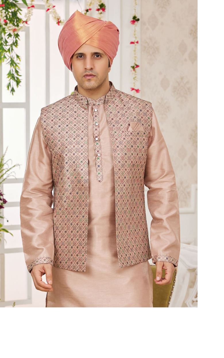 Man wearing a traditional pink and beige jacket with a matching turban indoors.