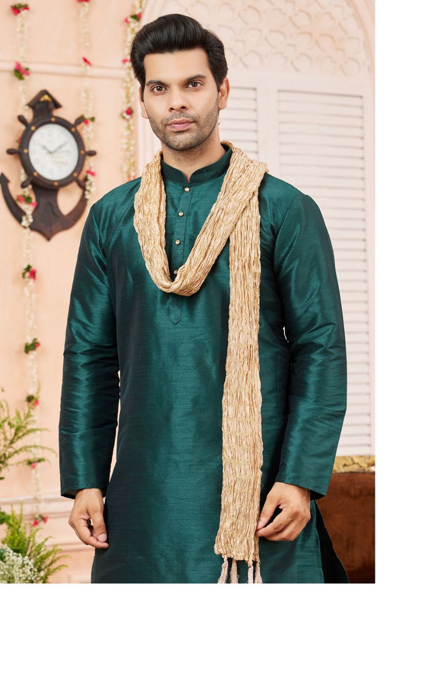 Man wearing a green kurta with a beige shawl indoors